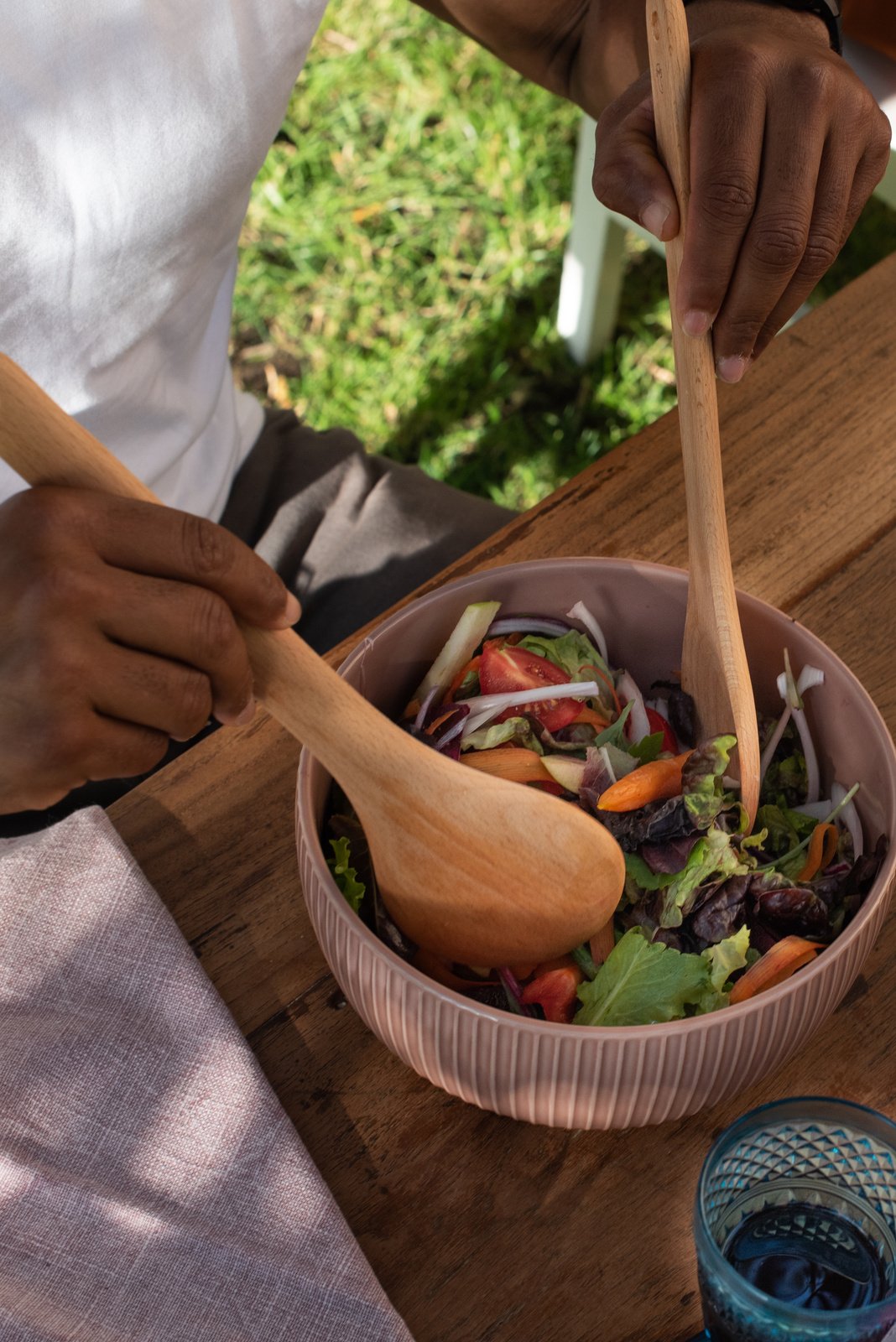 Woman Mixing Vegetable Salad in a Bowl